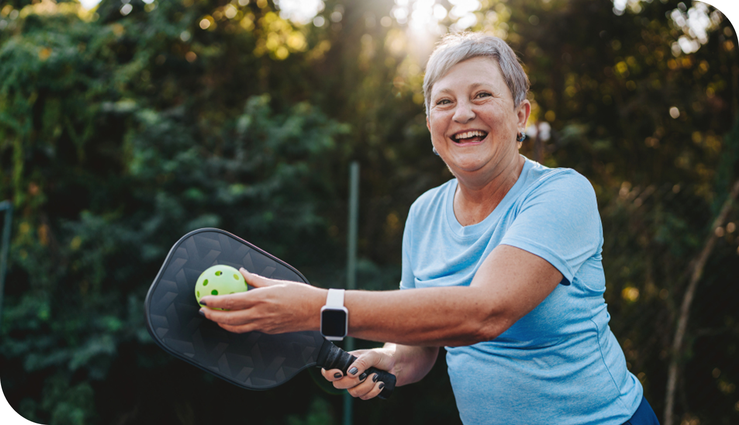 Grandparents standing in the front yard of their Wisconsin home, watching their grandchild run towards them.