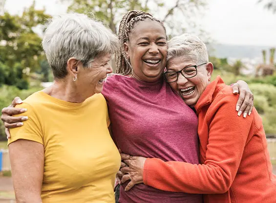 Friends laughing and hugging